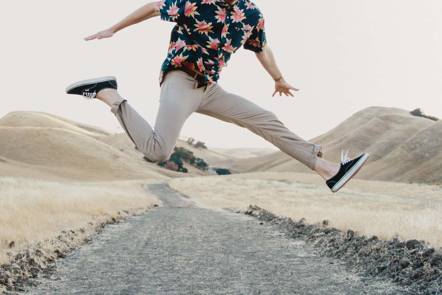 Guy jumping wearing chinos