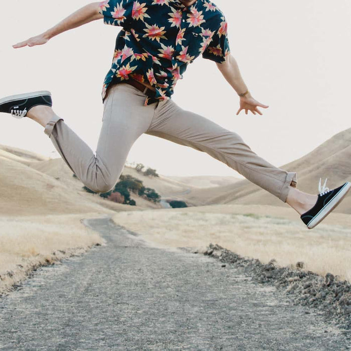 Guy jumping wearing chinos